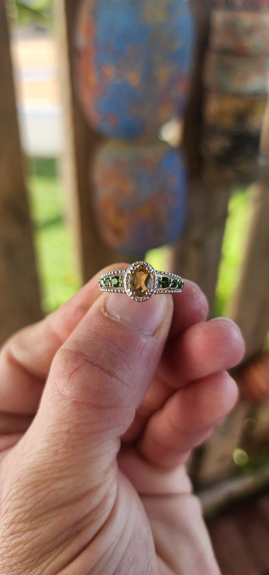This dazzling beauty is a half-eternity ring with a twist—a bold and funky fusion of citrus-bright and woodland-deep tones that makes her anything but ordinary.