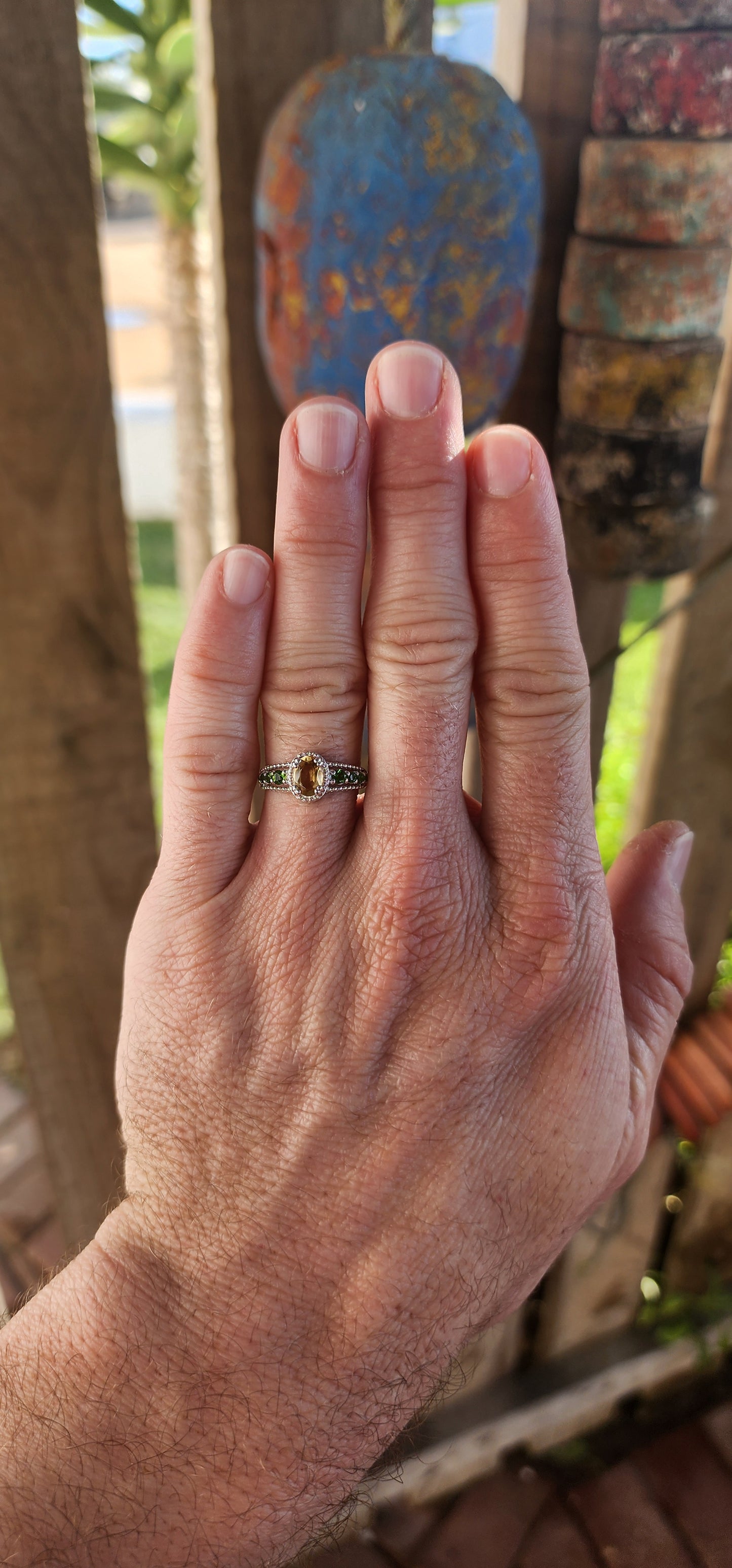 This dazzling beauty is a half-eternity ring with a twist—a bold and funky fusion of citrus-bright and woodland-deep tones that makes her anything but ordinary.