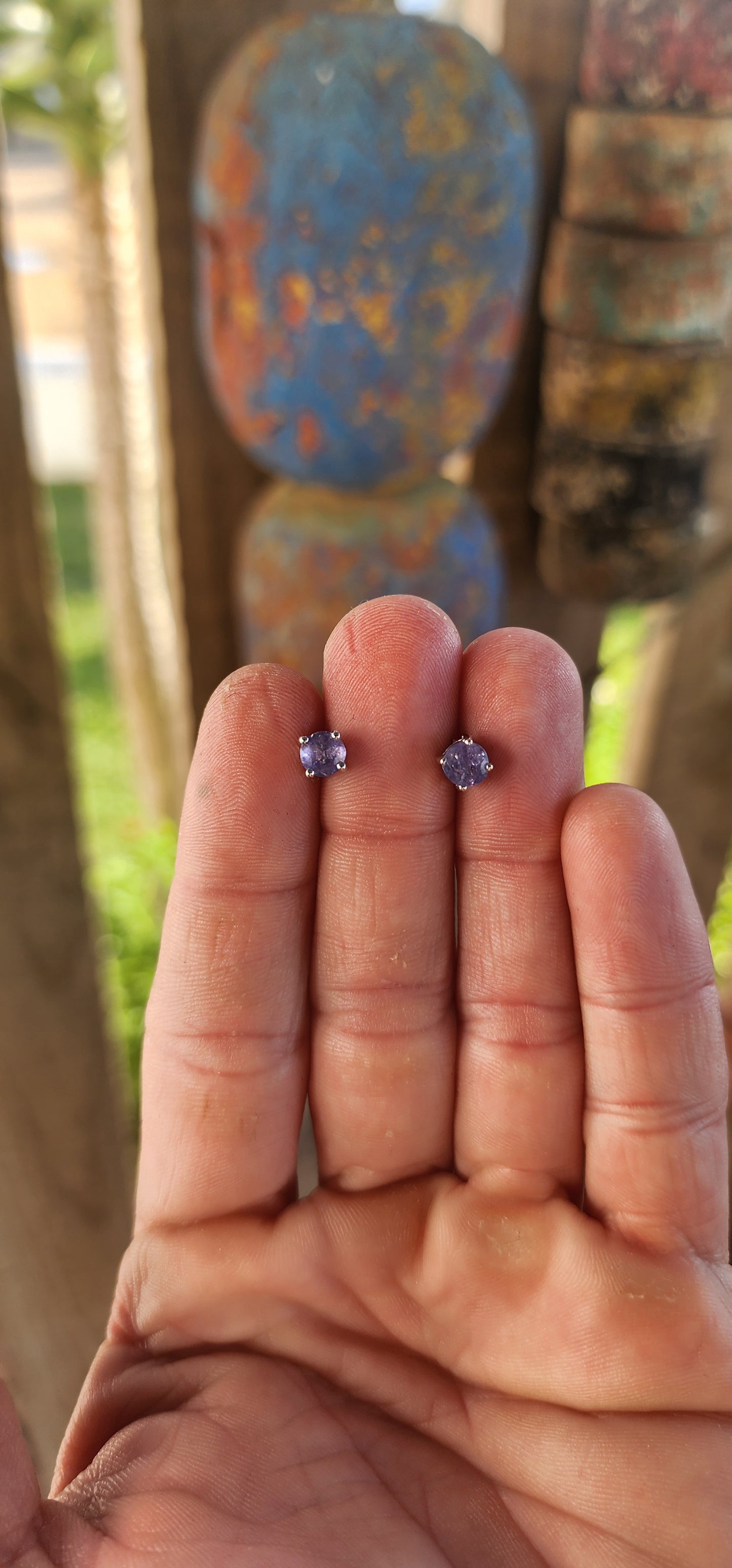 Small in size but rich in presence, these sterling silver stud earrings are a refined nod to nature’s twilight palette. Each earring showcases a captivating round-cut tanzanite—glowing with that unmistakable periwinkle hue.