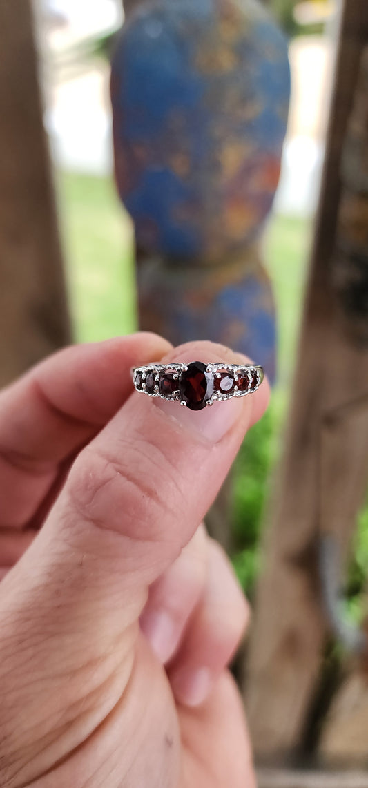 Ignite your fingers with this fiery beauty! Crafted in luminous sterling silver and finished with a high-polish rhodium plating to keep it forever bright, this exquisite half-eternity ring is pure gemstone poetry.