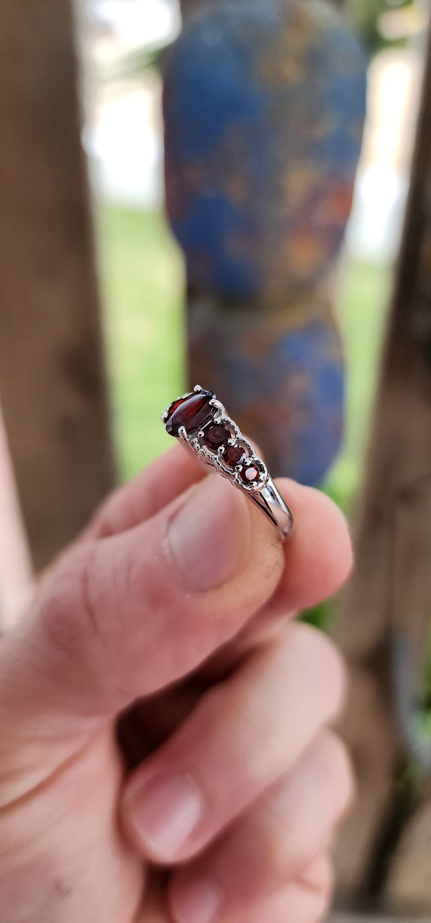 Ignite your fingers with this fiery beauty! Crafted in luminous sterling silver and finished with a high-polish rhodium plating to keep it forever bright, this exquisite half-eternity ring is pure gemstone poetry.