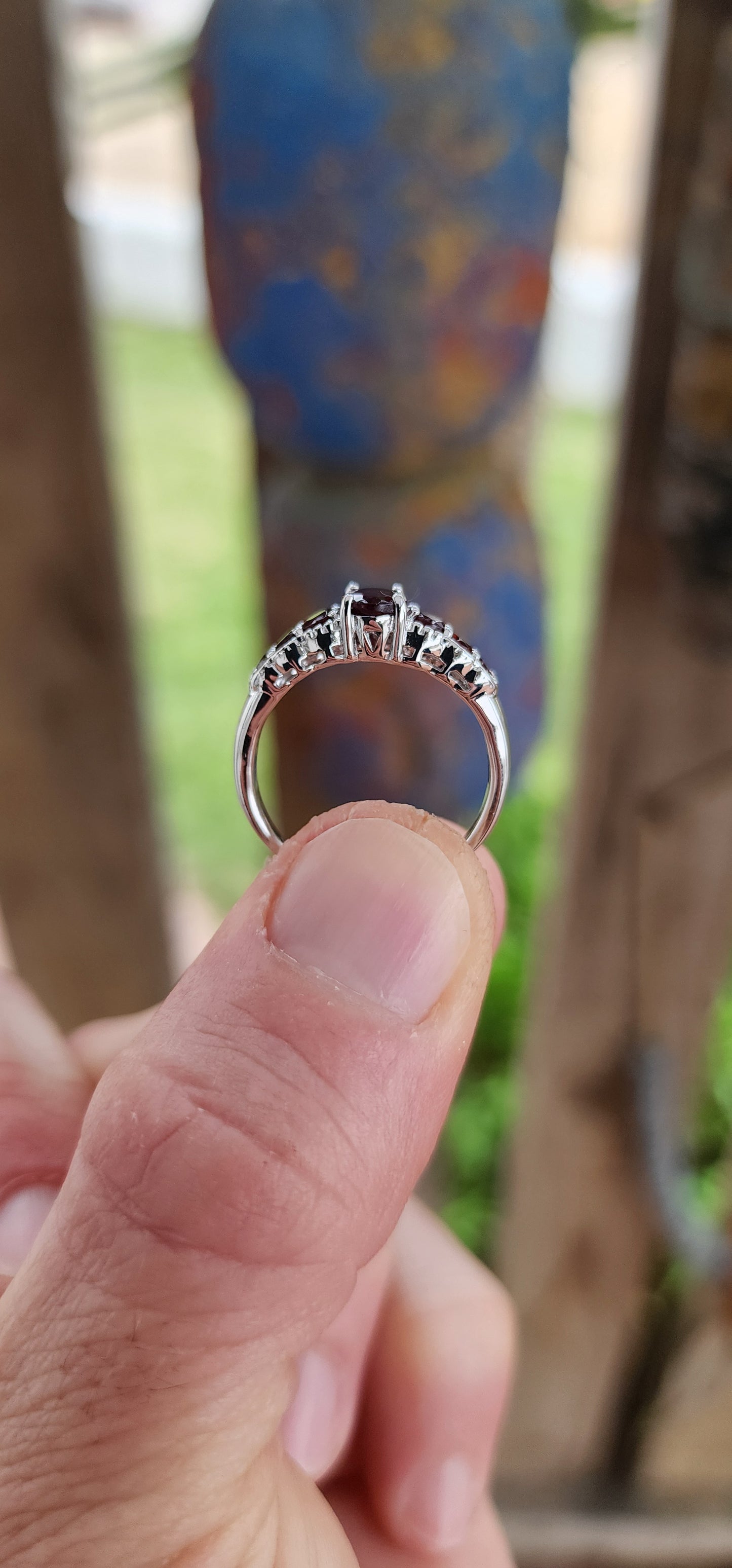 Ignite your fingers with this fiery beauty! Crafted in luminous sterling silver and finished with a high-polish rhodium plating to keep it forever bright, this exquisite half-eternity ring is pure gemstone poetry.