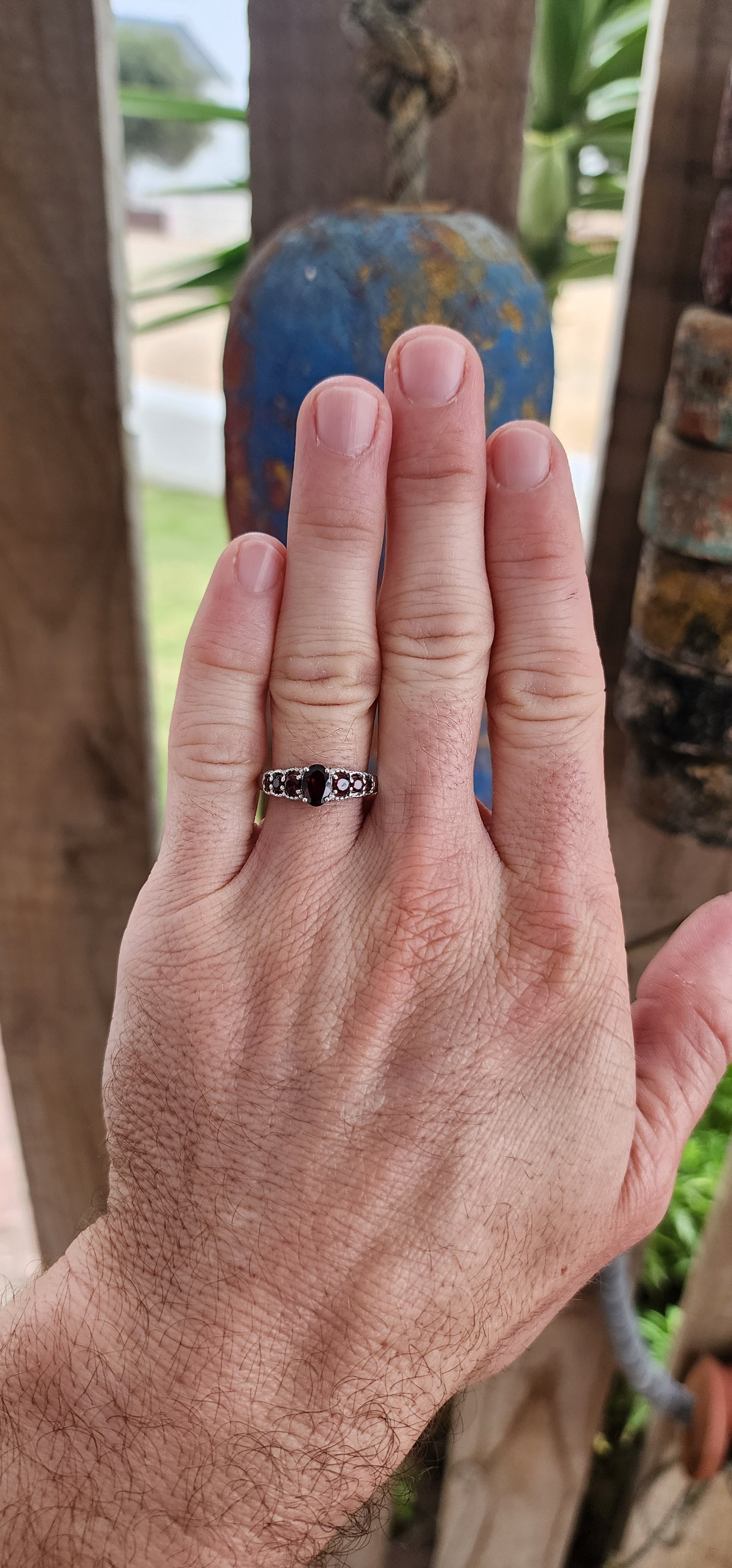 Ignite your fingers with this fiery beauty! Crafted in luminous sterling silver and finished with a high-polish rhodium plating to keep it forever bright, this exquisite half-eternity ring is pure gemstone poetry.
