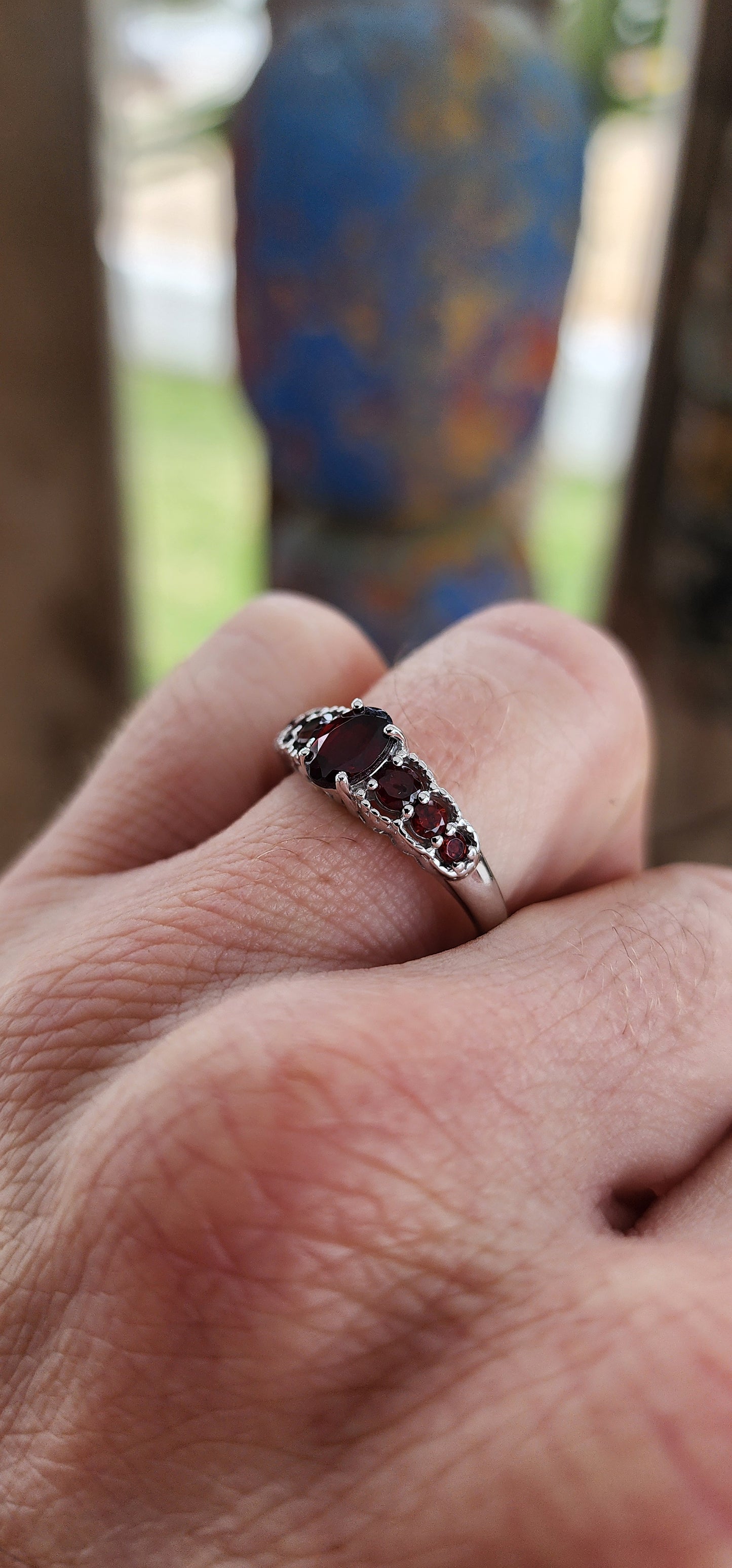 Ignite your fingers with this fiery beauty! Crafted in luminous sterling silver and finished with a high-polish rhodium plating to keep it forever bright, this exquisite half-eternity ring is pure gemstone poetry.