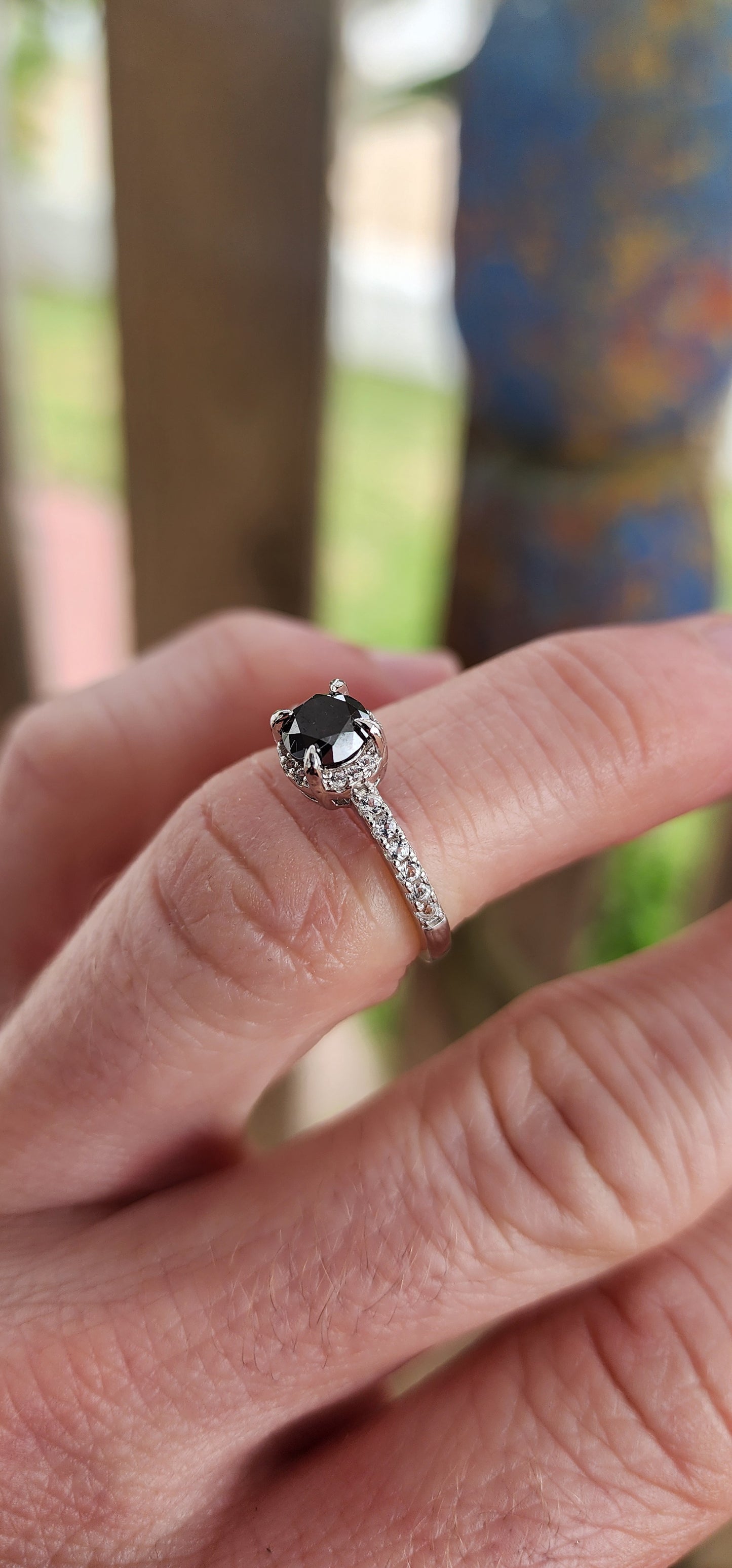 Prepare to swoon—this breathtaking sterling silver solitaire ring is pure romantic rebellion. At its heart sits a bold and dramatic round-cut black diamond, prong-set in gothic claw-like talons that grip it like a dragon guards its treasure.