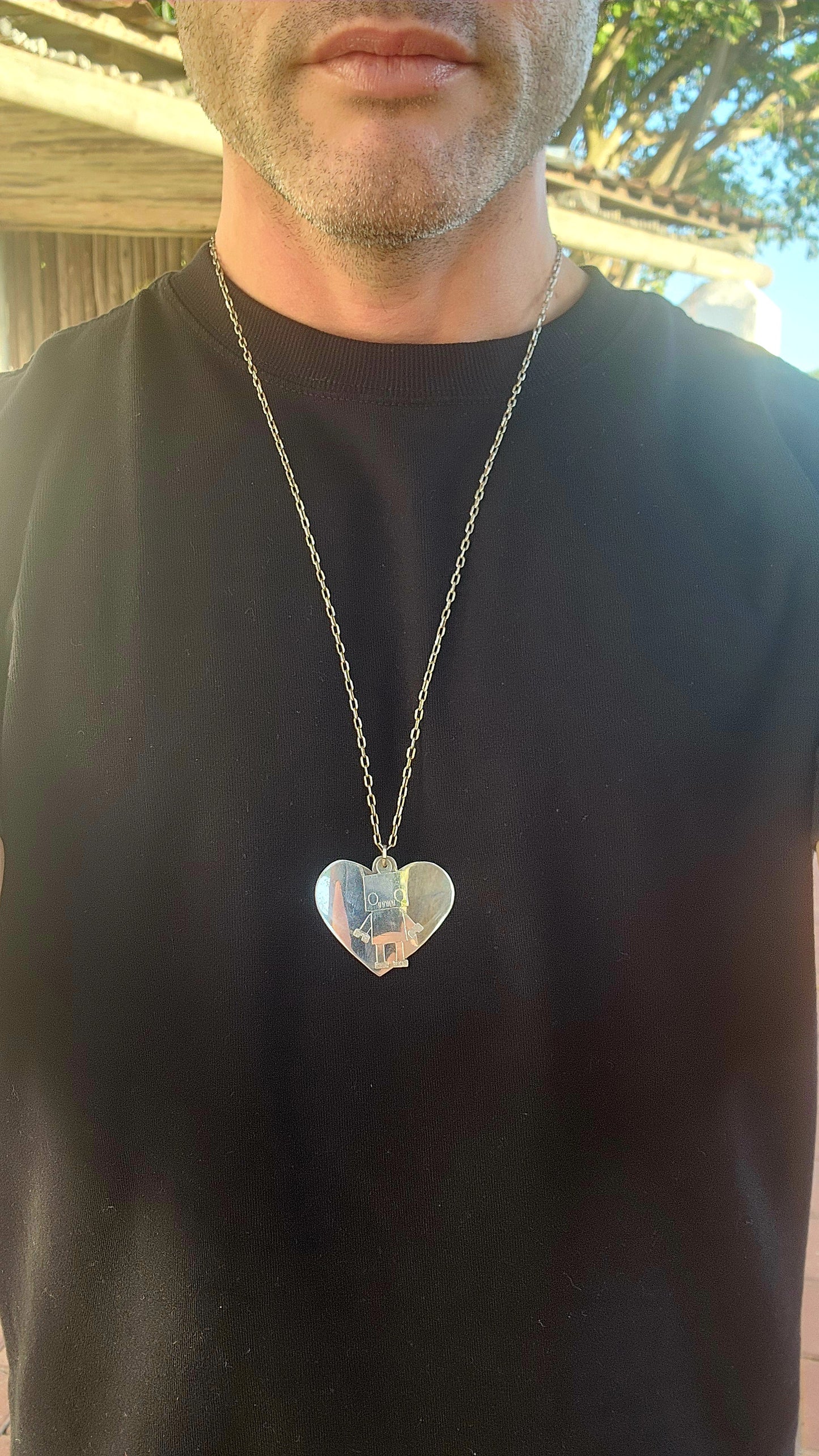 This necklace is pure quirky charm meets retro-futuristic flair!
Crafted in sterling silver, this artisan-made, extra-length necklace features a playful pendant duo that’s sure to spark conversation wherever you go.