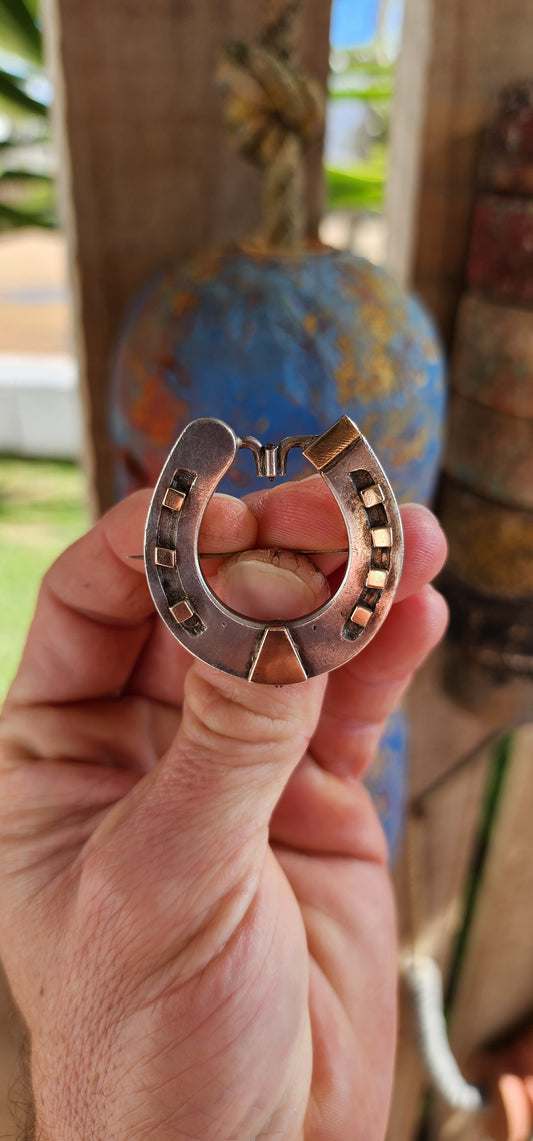 Rare and commanding Victorian era lucky horseshoe brooch, masterfully crafted in solid sterling silver and adorned with 9ct rose gold accents. Measuring large and weighty, this brooch doesn’t whisper luck—it proclaims it.