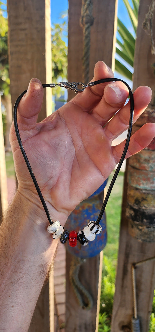 Channeling both modern cool and mystical charm, this unisex designer necklace by T-r-o-l-l-b-e-a-d-s is a wearable piece of art.