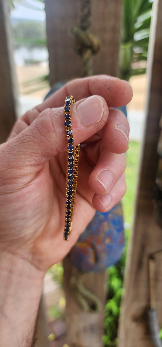"Midnight Serenade" – A Sapphire Tennis bracelet"
Crafted in gleaming sterling silver and bathed in rich 18ct yellow gold plating.