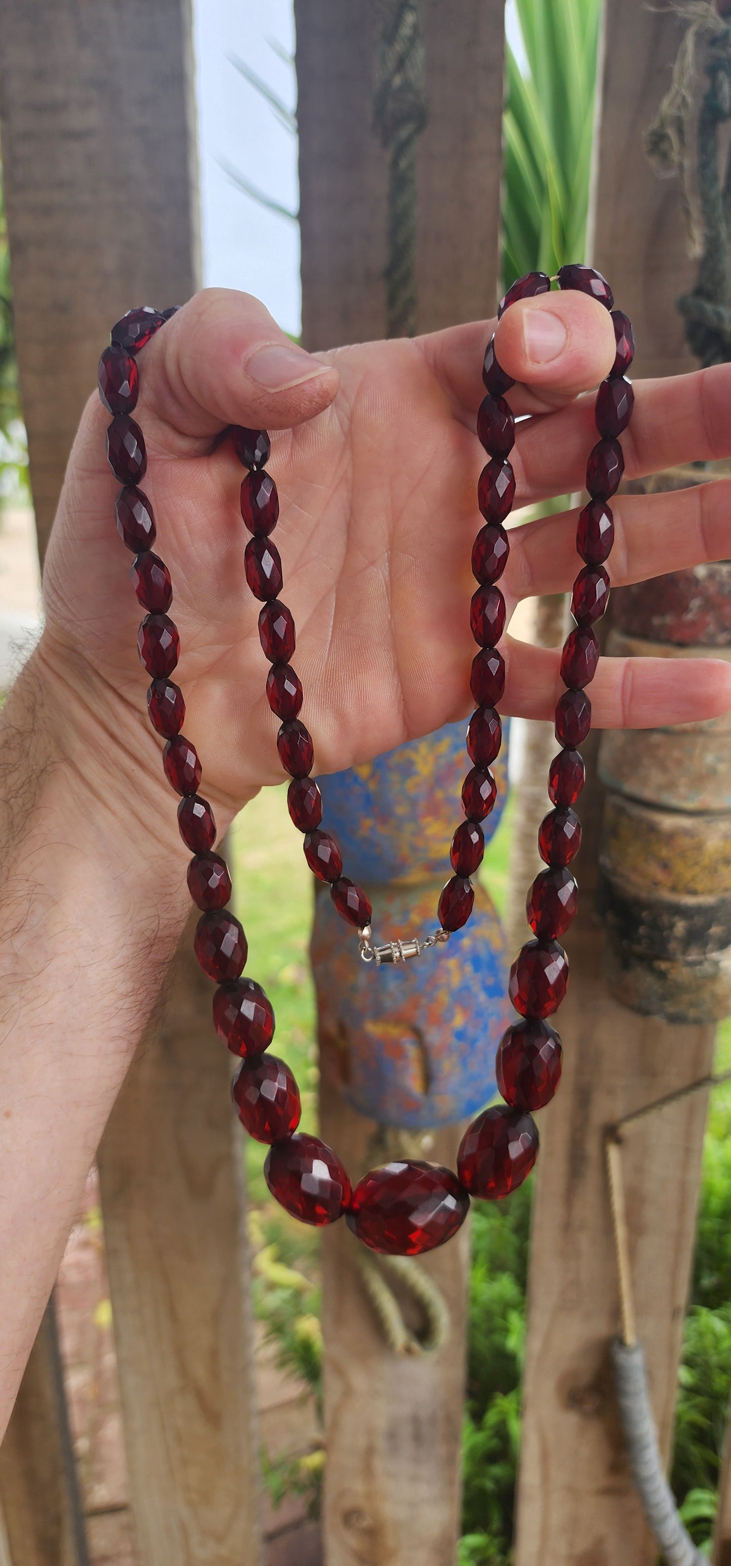 This exquisite vintage necklace is a radiant example of 1930s Art Deco glamour, showcasing hand-faceted cherry Bakelite beads in a beautifully graduated design.