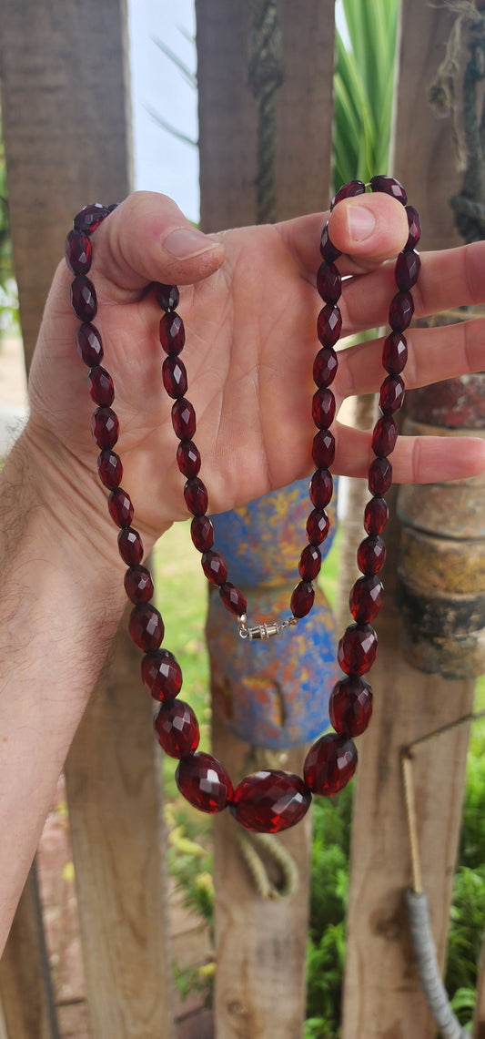 This exquisite vintage necklace is a radiant example of 1930s Art Deco glamour, showcasing hand-faceted cherry Bakelite beads in a beautifully graduated design.