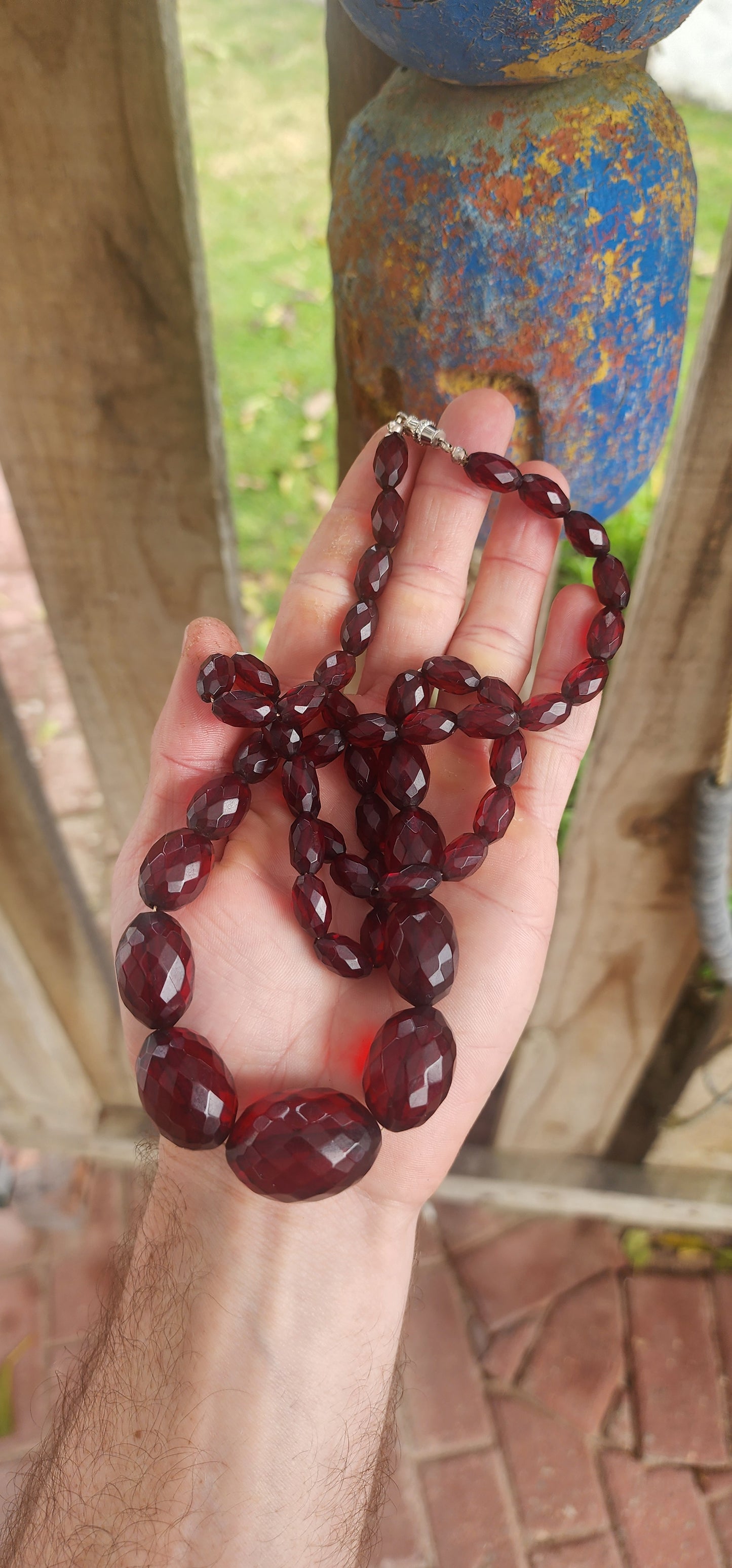 This exquisite vintage necklace is a radiant example of 1930s Art Deco glamour, showcasing hand-faceted cherry Bakelite beads in a beautifully graduated design.