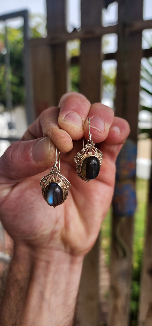These enchanting sterling silver drop earrings are a romantic nod to the Art Nouveau era, featuring oval labradorite cabochons bezel-set atop intricate lace-like filigree backings.
