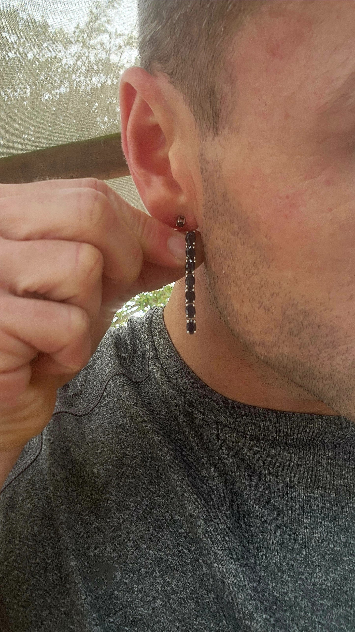 These sterling silver dangle earrings are designed to showcase the mysterious beauty of deep blue sapphires.