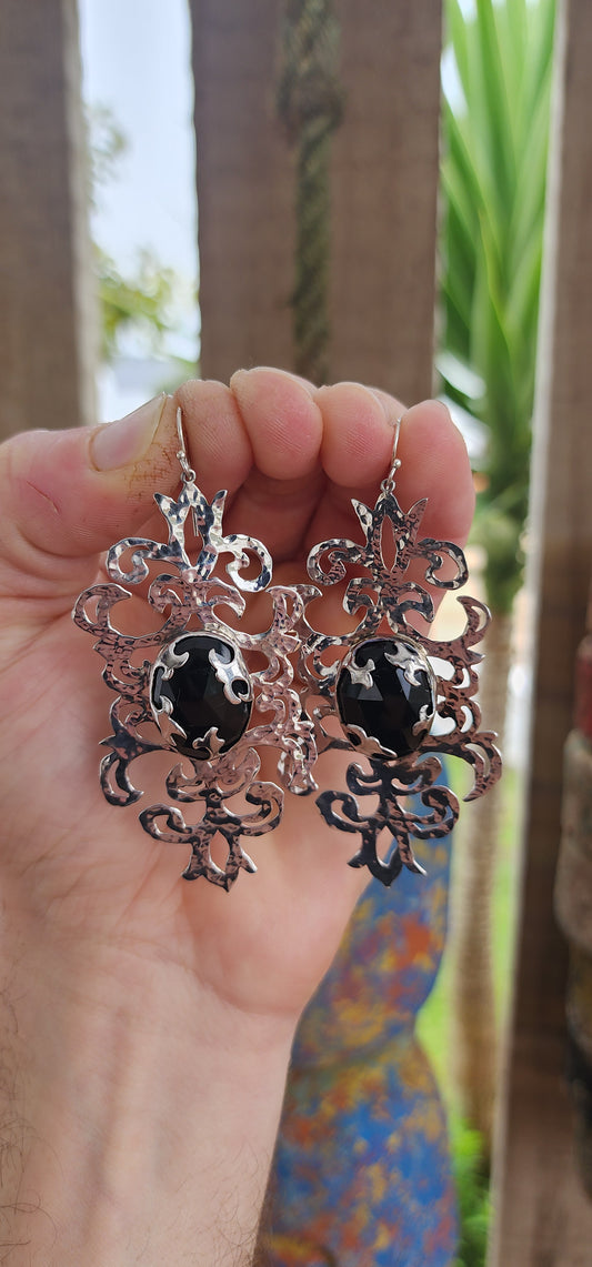 Absolutely striking and unapologetically bold — these statement earrings are a celebration of intricate craftsmanship and gothic elegance, brought to life by the acclaimed South African jewelry brand Topiary and Ashe.