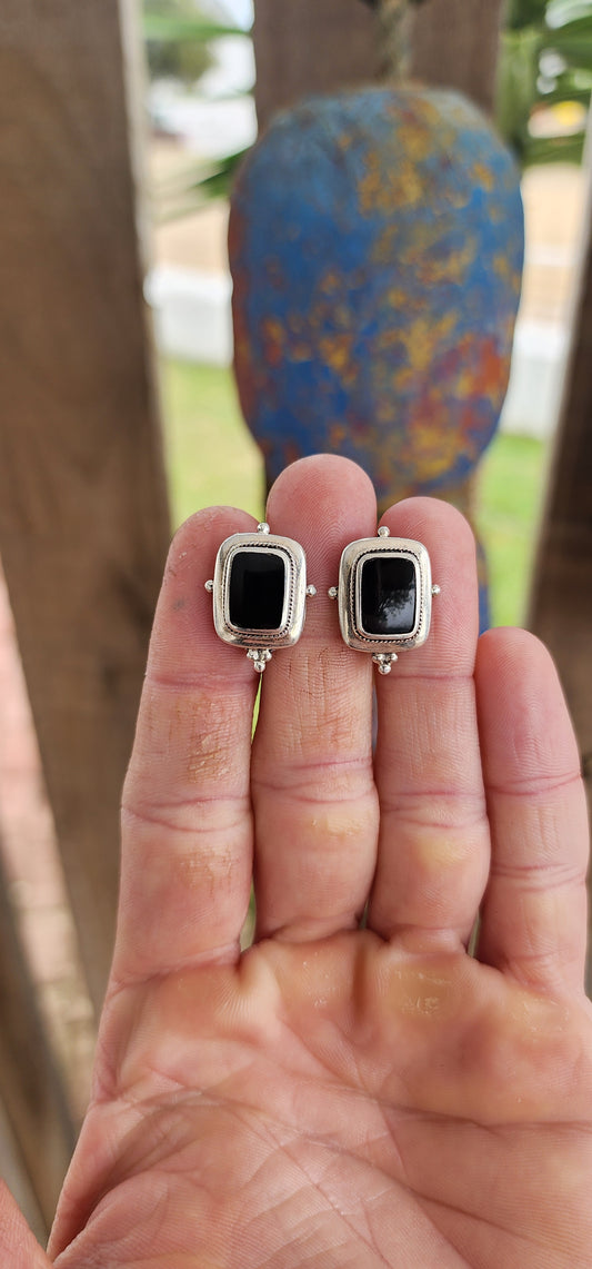 Timeless with a bold, tailored edge, this vintage pair of sterling silver push-in earrings is a striking example of balance between structure and mystique.