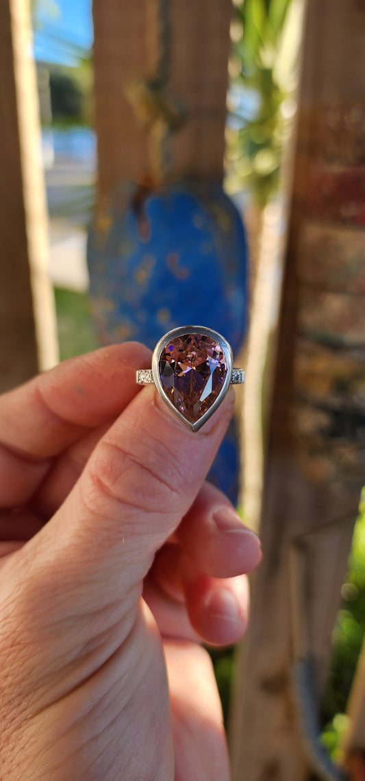 Blast off in style with this chunky sterling silver statement ring! Crafted from solid sterling silver, this bold beauty shows off a mouthwatering and large sized, pear-shaped pink CZ.