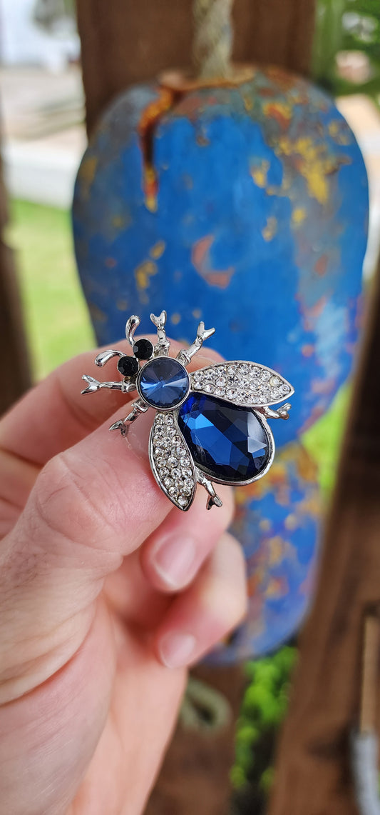 Whimsical beetle-shaped costume brooch, bursting with playful elegance and a hint of vintage-inspired flair. Crafted from silvertone metal, this eye-catching piece transforms an ordinary insect motif into a sparkling delight.