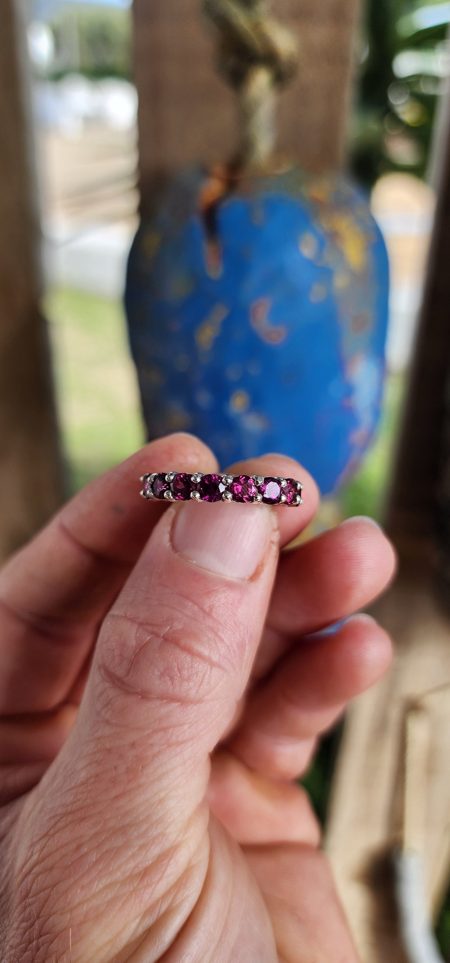 This sterling silver full eternity ring is set with 17 round-cut rhodolite garnets, each one meticulously claw-set to form an unbroken circle of luminous berry brilliance.