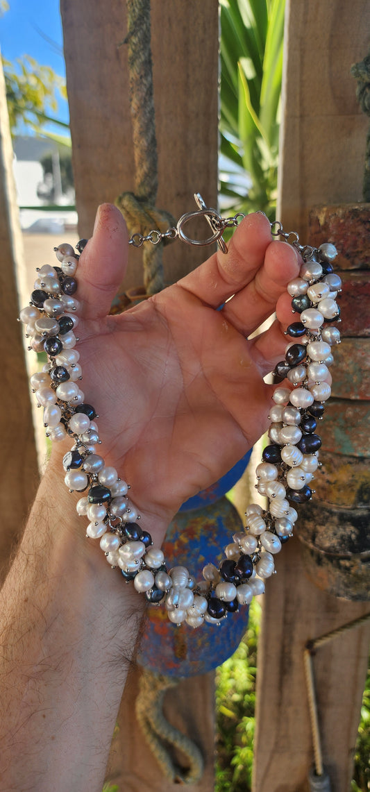 A bold twist on classic elegance — this magnificent statement necklace bursts with organic charm and lush texture!
