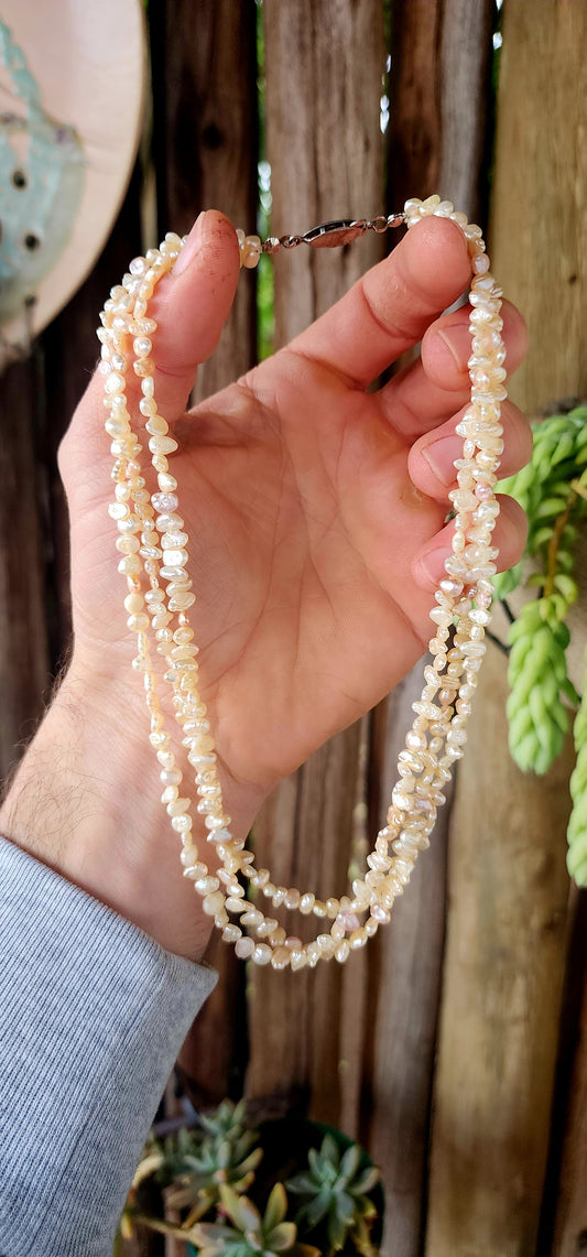 This beautiful vintage art deco era necklace showcases three strands of luminous freshwater keshi rice pearls, each with its own unique, organic shape.