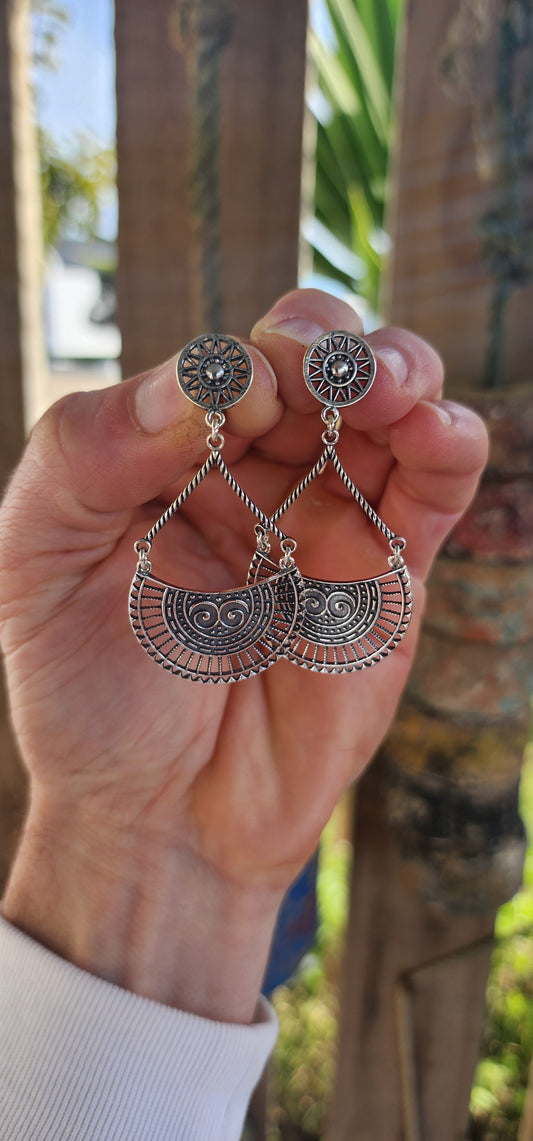 These striking earrings are crafted in solid sterling silver, showcasing a bold bohemian–tribal aesthetic that’s both artistic and wearable.
