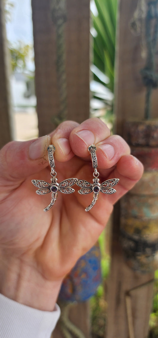 Gracefully suspended in sterling silver, these captivating dragonfly push-in earrings are more than mere adornments — they are talismans of transformation and light.