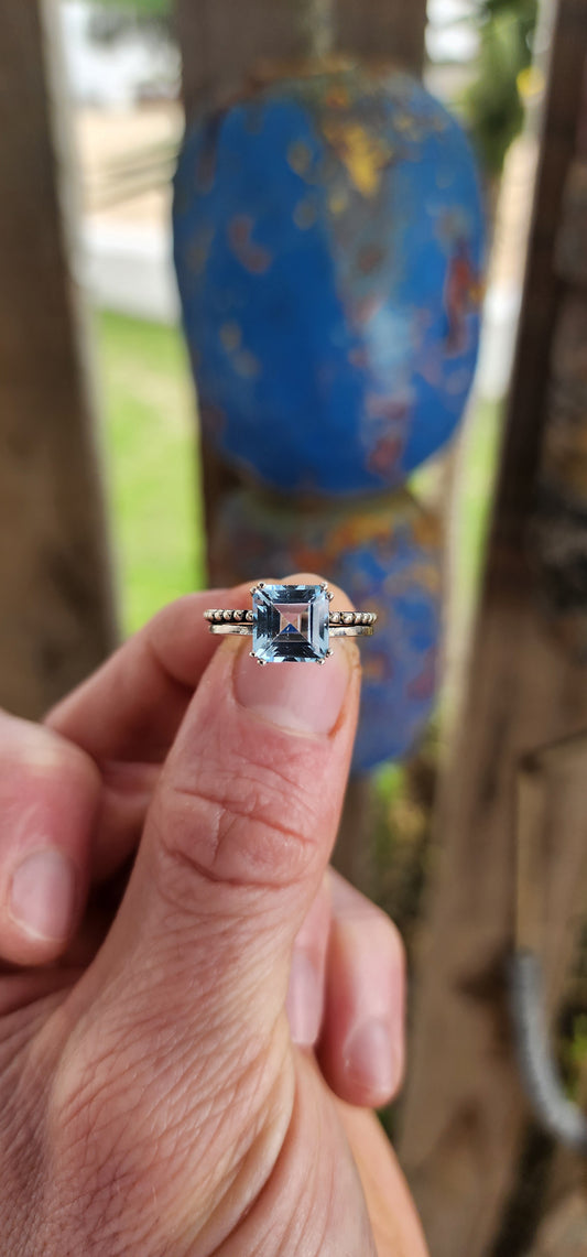 This elegant ring is crafted in polished sterling silver, showcasing a striking solitaire sky blue topaz as its centerpiece.
