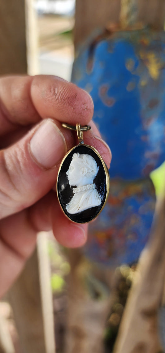 This is an antique Victorian-era cameo pendant, dating from the mid-to-late 19th century, crafted in the popular Neoclassical Revival style that dominated jewelry of the time.