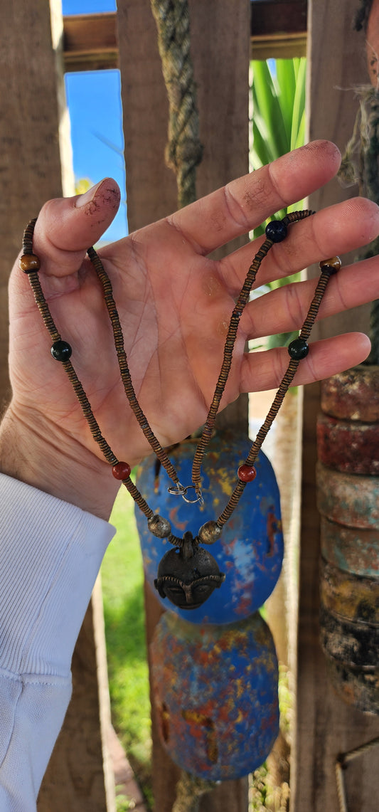 This striking vintage ethnic statement necklace hails from Ghana West Africa, where jewelry and adornment are deeply tied to cultural identity and symbolism.