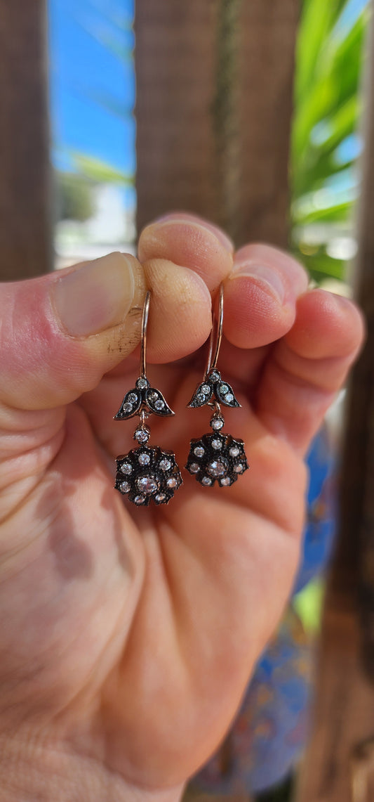 These elegant earrings are crafted in sterling silver and display a refined Victorian revival design that captures the romantic spirit of 19th-century jewelry.