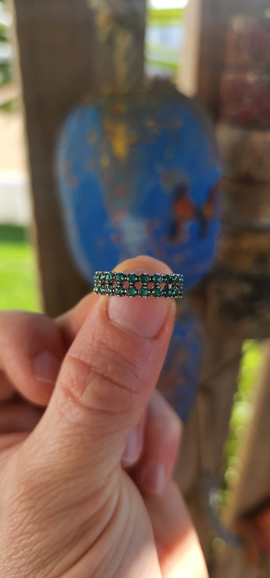 This sterling silver half-eternity ring breathes fresh, verdant energy , set with not one but two shimmering rows of round-cut green chalcedony gemstones.