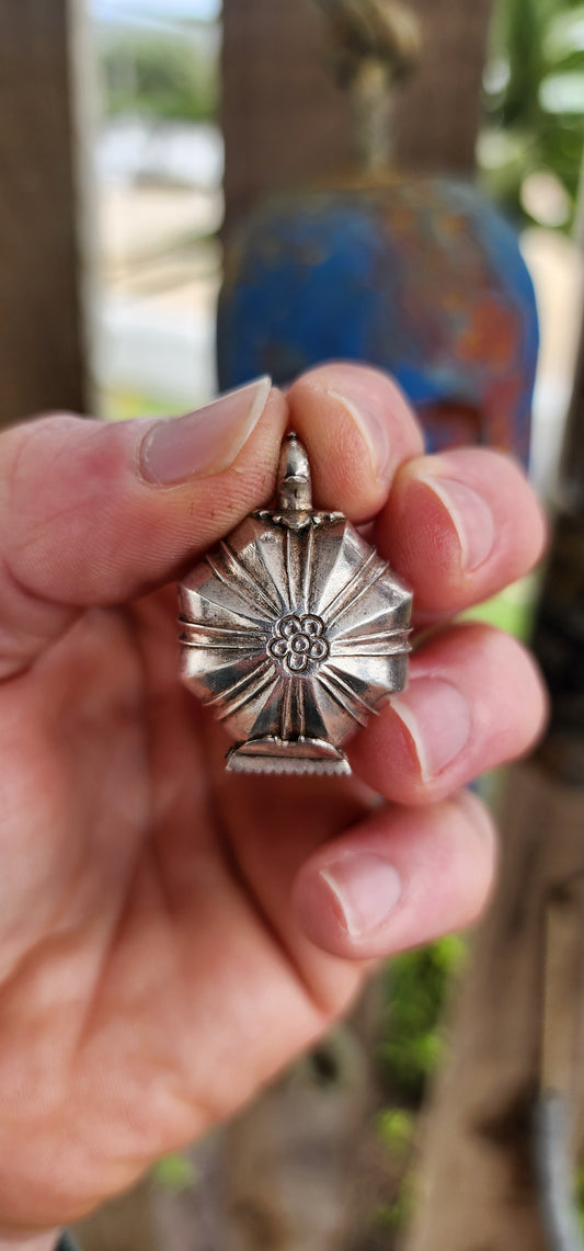 This marvelous and unusual antique sterling silver locket comes from Sri Lanka and is steeped in rich cultural tradition. Crafted in a bold hexagonal form, it is designed as a hinged container once used to hold betel and lime paste.