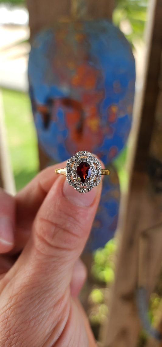 This enchanting vintage style halo ring is expertly crafted in sterling silver and luxuriously finished with a warm layer of 18ct yellow gold plating that lends it a rich and regal glow.