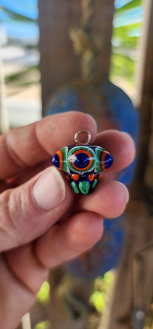 A true burst of color and imagination! This unusual and funky artisan-made pendant has been crafted using the age-old lampwork glass technique, resulting in a miniature piece of wearable art.