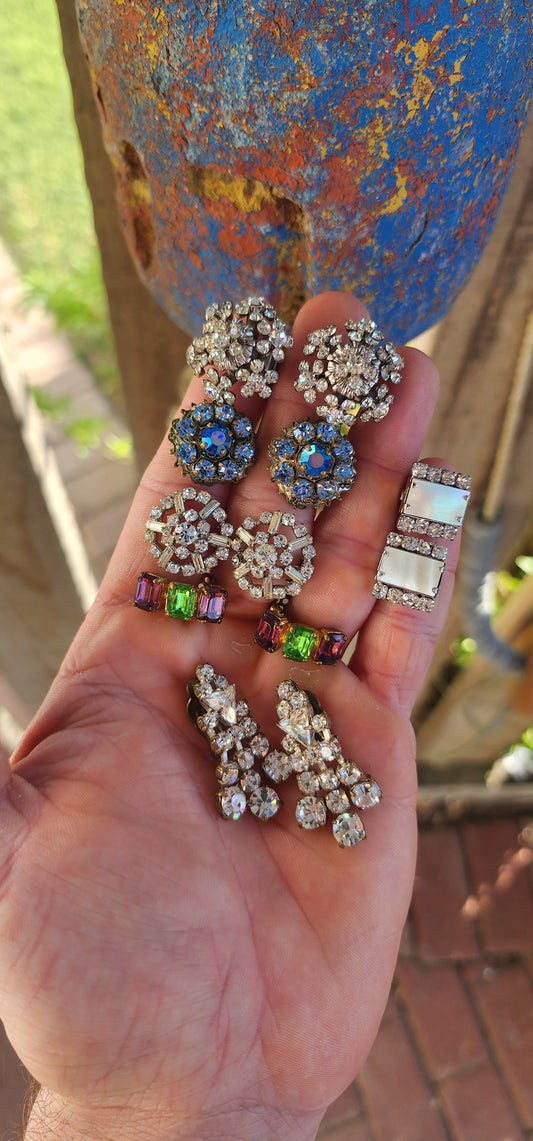 Glam Squad in a Handful.
Here’s a sparkling treasure trove of six pairs of vintage 1950s/60s costume clip-on earrings.