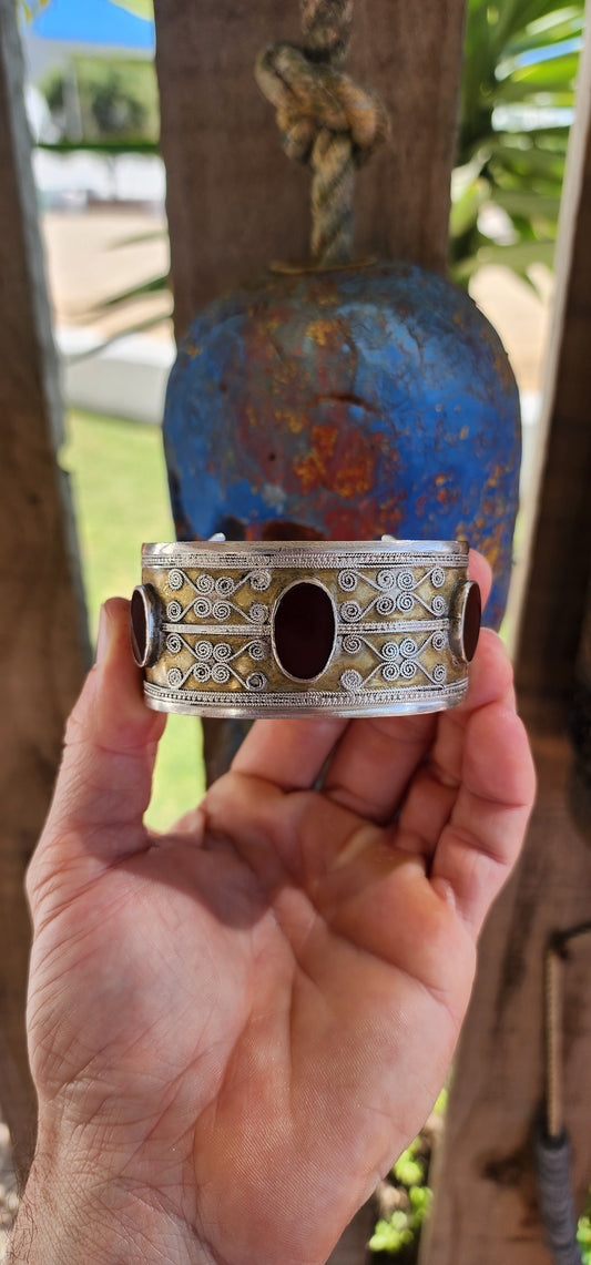 A striking and weighty solid sterling silver open cuff bangle, crafted by the nomadic Tekke tribe of Turkmenistan circa 1920s. This imposing piece embodies the opulence and symbolism of traditional ethnic Afghan/Turkoman adornment.