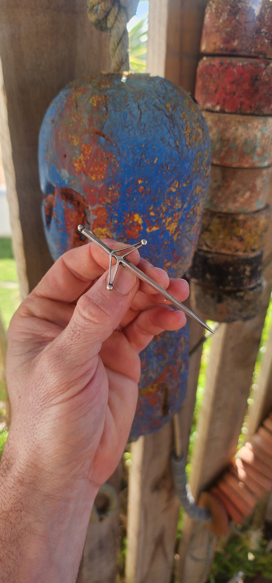 A striking vintage hallmarked sterling silver Scottish kilt pin brooch, beautifully modeled in the form of a traditional Highland sword—often referred to as a claymore.