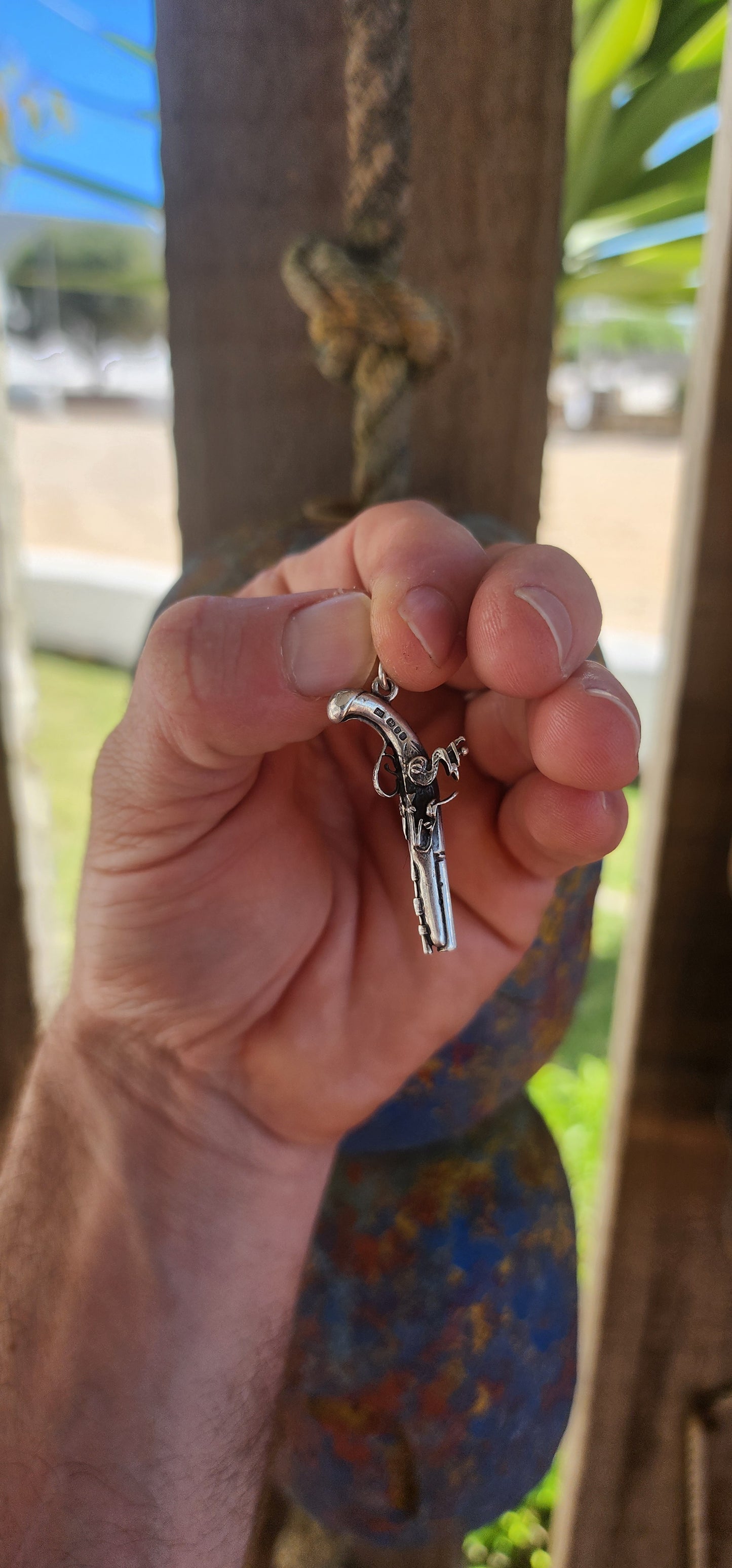 Vintage hallmarked sterling silver novelty pocket watch winding key fob pendant, exquisitely crafted in the shape of a miniature flintlock pistol.