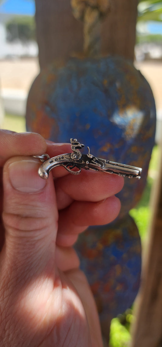 Vintage hallmarked sterling silver novelty pocket watch winding key fob pendant, exquisitely crafted in the shape of a miniature flintlock pistol.
