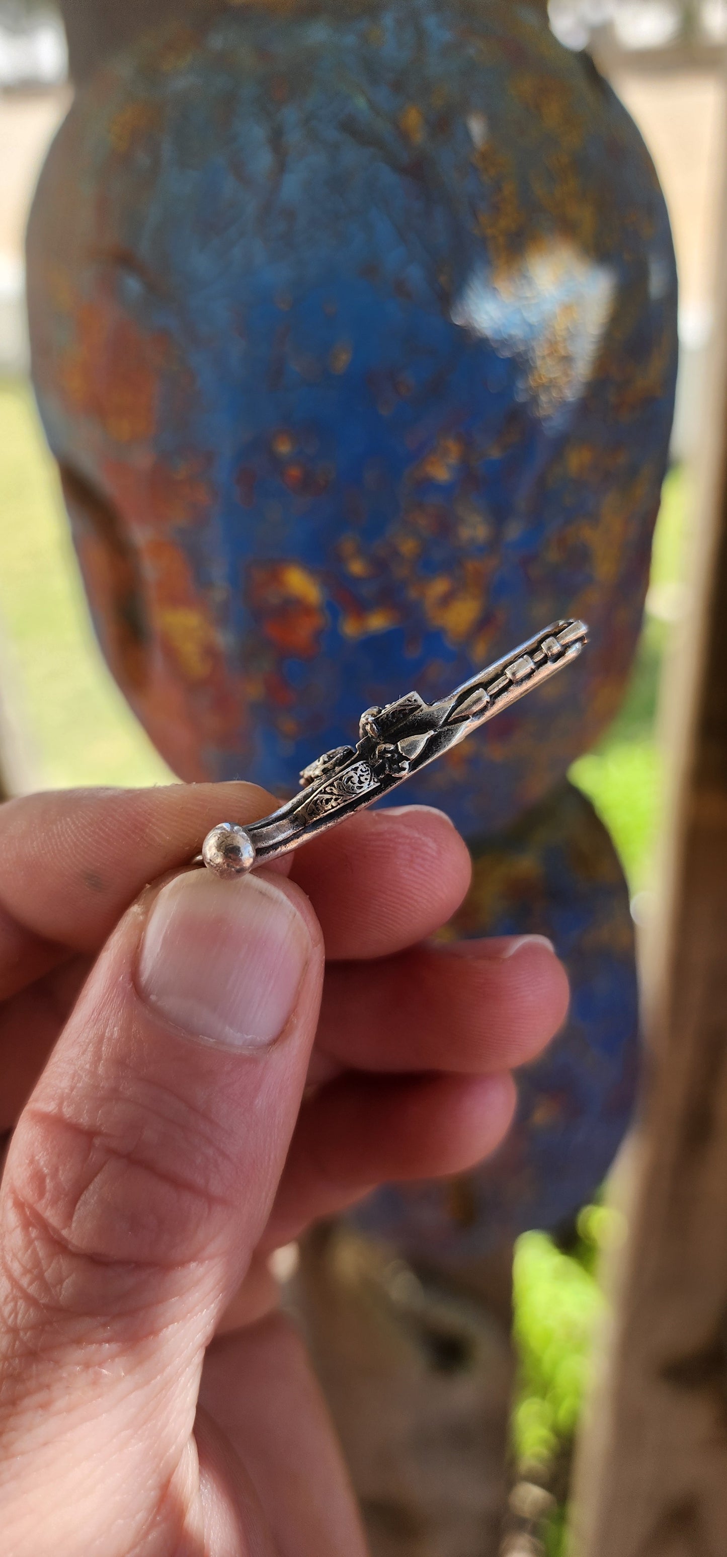 Vintage hallmarked sterling silver novelty pocket watch winding key fob pendant, exquisitely crafted in the shape of a miniature flintlock pistol.