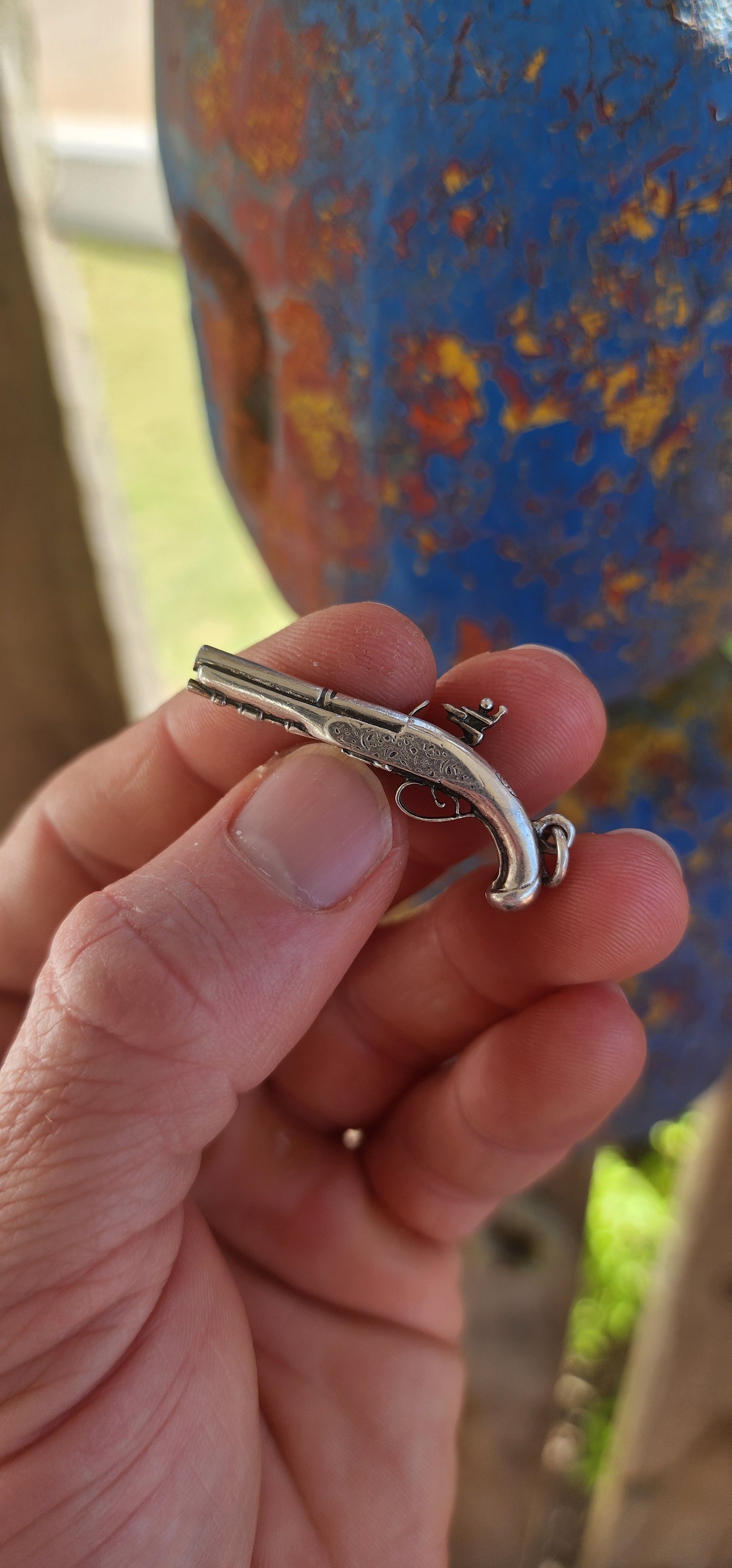 Vintage hallmarked sterling silver novelty pocket watch winding key fob pendant, exquisitely crafted in the shape of a miniature flintlock pistol.