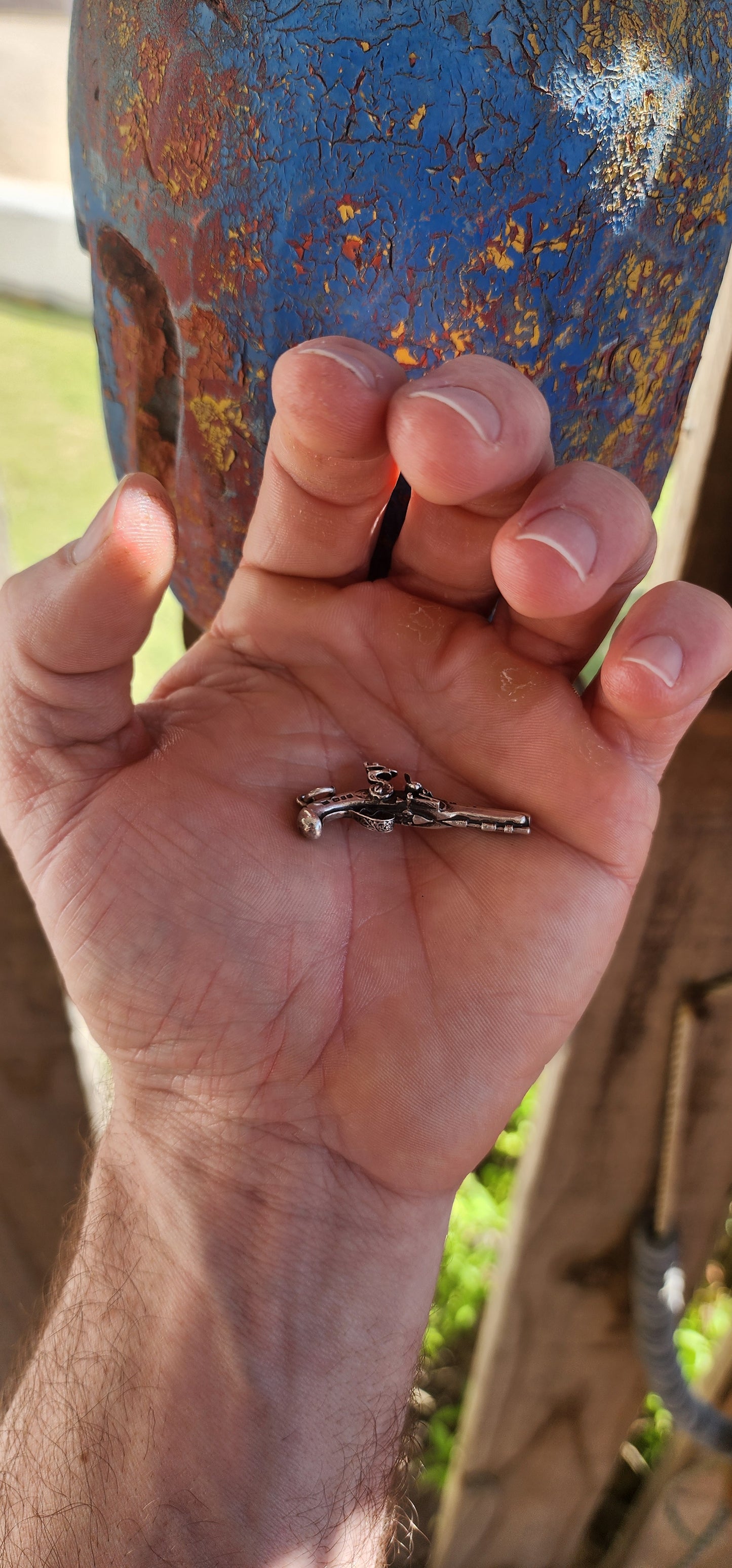 Vintage hallmarked sterling silver novelty pocket watch winding key fob pendant, exquisitely crafted in the shape of a miniature flintlock pistol.