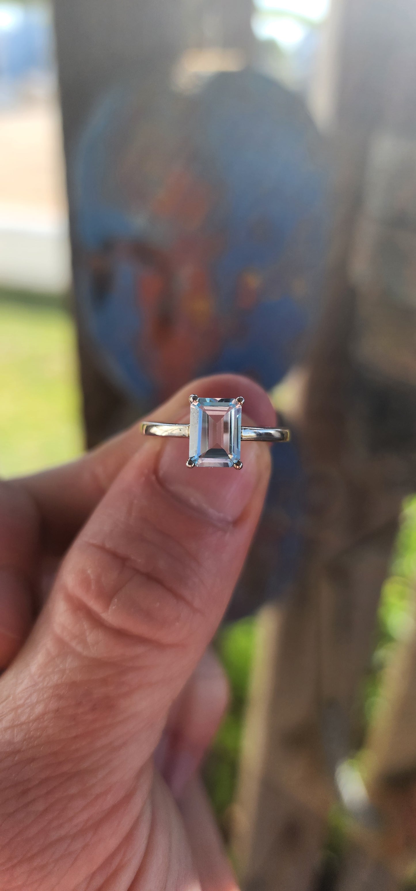 Beautifully crafted sterling silver solitaire ring.
At its heart lies a captivating emerald-cut sky blue topaz, held securely in a four-prong raised basket.