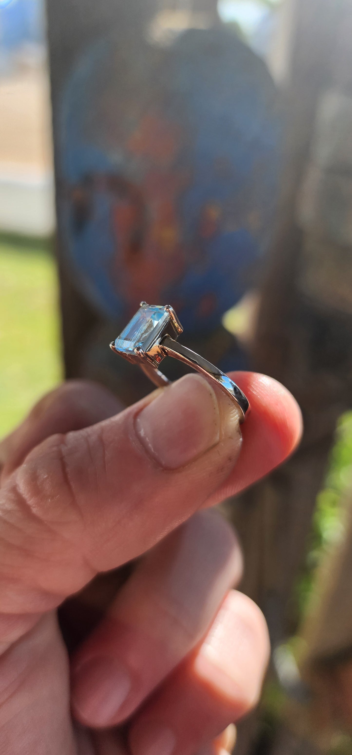 Beautifully crafted sterling silver solitaire ring.
At its heart lies a captivating emerald-cut sky blue topaz, held securely in a four-prong raised basket.
