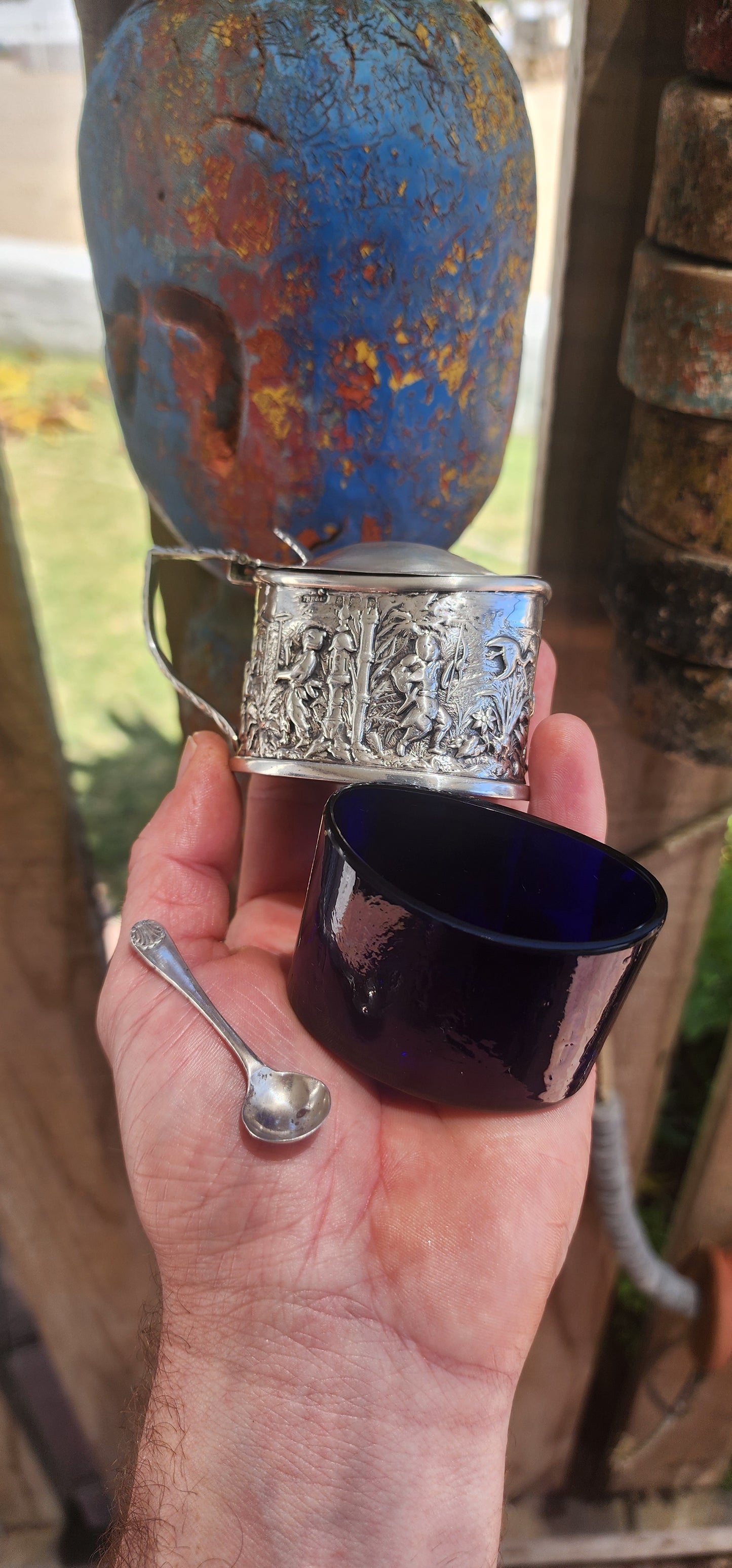 A beautiful example of Edwardian fascination with the “mystique of the East,” this circa 1902 hallmarked sterling silver mustard pot is richly cast in high relief with scenes of traditional life.