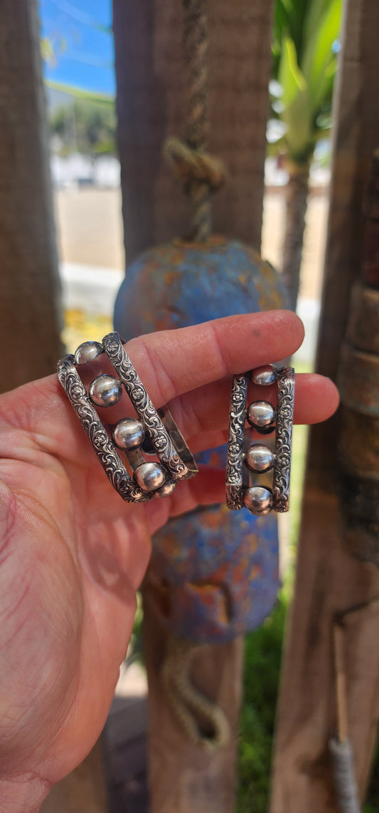 A beautifully matched pair of vintage sterling silver napkin rings by the highly sought-after South African silversmith Joe Calafato, working under his renowned studio name Candida.