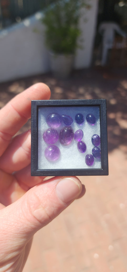 A dreamy, colour-rich parcel totalling 27 carats of genuine amethyst cabochons in a charming mix of round, pear, and oval shapes.