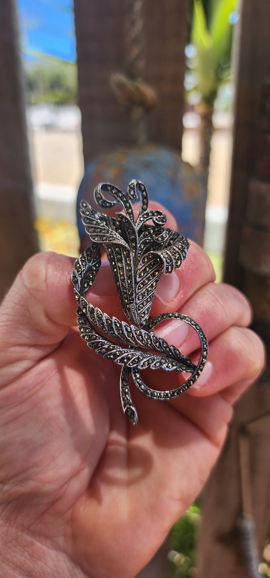 A truly captivating Art Deco-era treasure, this large, sculptural floral brooch dates to the 1930s and is crafted in solid sterling silver, beautifully rhodium-plated to preserve its brilliance.