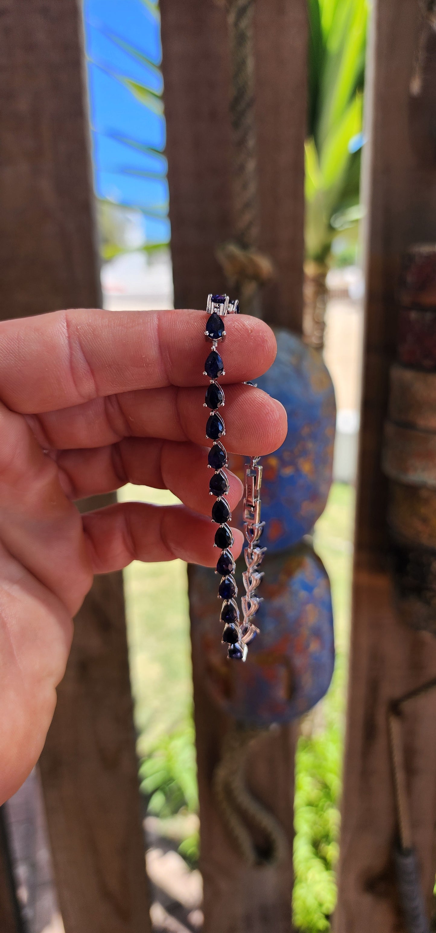 Breathtakingly beautiful sterling silver tennis bracelet, shimmering with 25 pear-cut deep-blue sapphires.